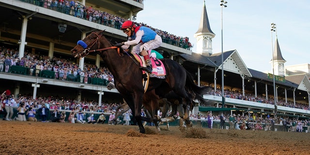 John Velazquez riding Medina Spirit crosses the finish line to win the 147th running of the Kentucky Derby at Churchill Downs in Louisville, Kentucky, May 1, 2021.