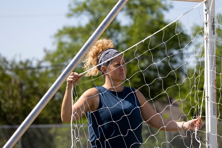 Jen Anthony, co-founder of Nets on the Run, installs a new soccer net at Woodstone Elementary School on Saturday.